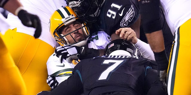 Aaron Rodgers #12 of the Green Bay Packers is sacked by Brandon Graham #55 of the Philadelphia Eagles during the third quarter at Lincoln Financial Field on November 27, 2022 in Philadelphia, Pennsylvania.