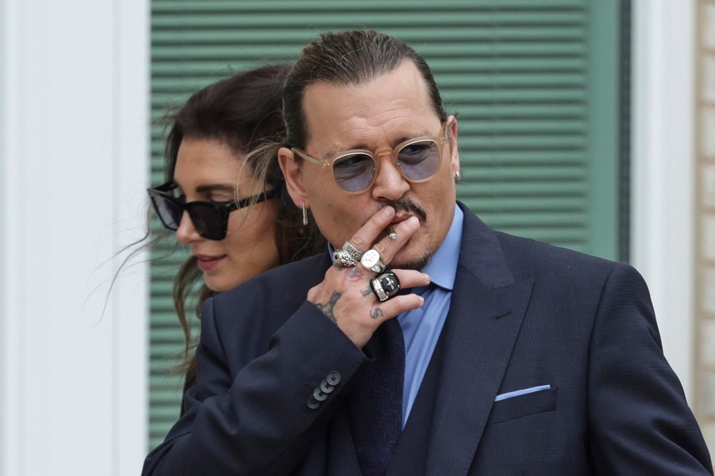 Johnny Depp smokes during a break in his trial at a Fairfax County Courthouse on May 27 in Fairfax, Virginia.