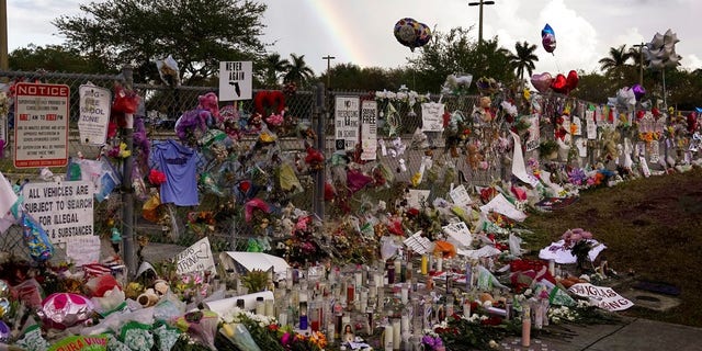 A memorial is placed outside Marjory Stoneman Douglas High School.