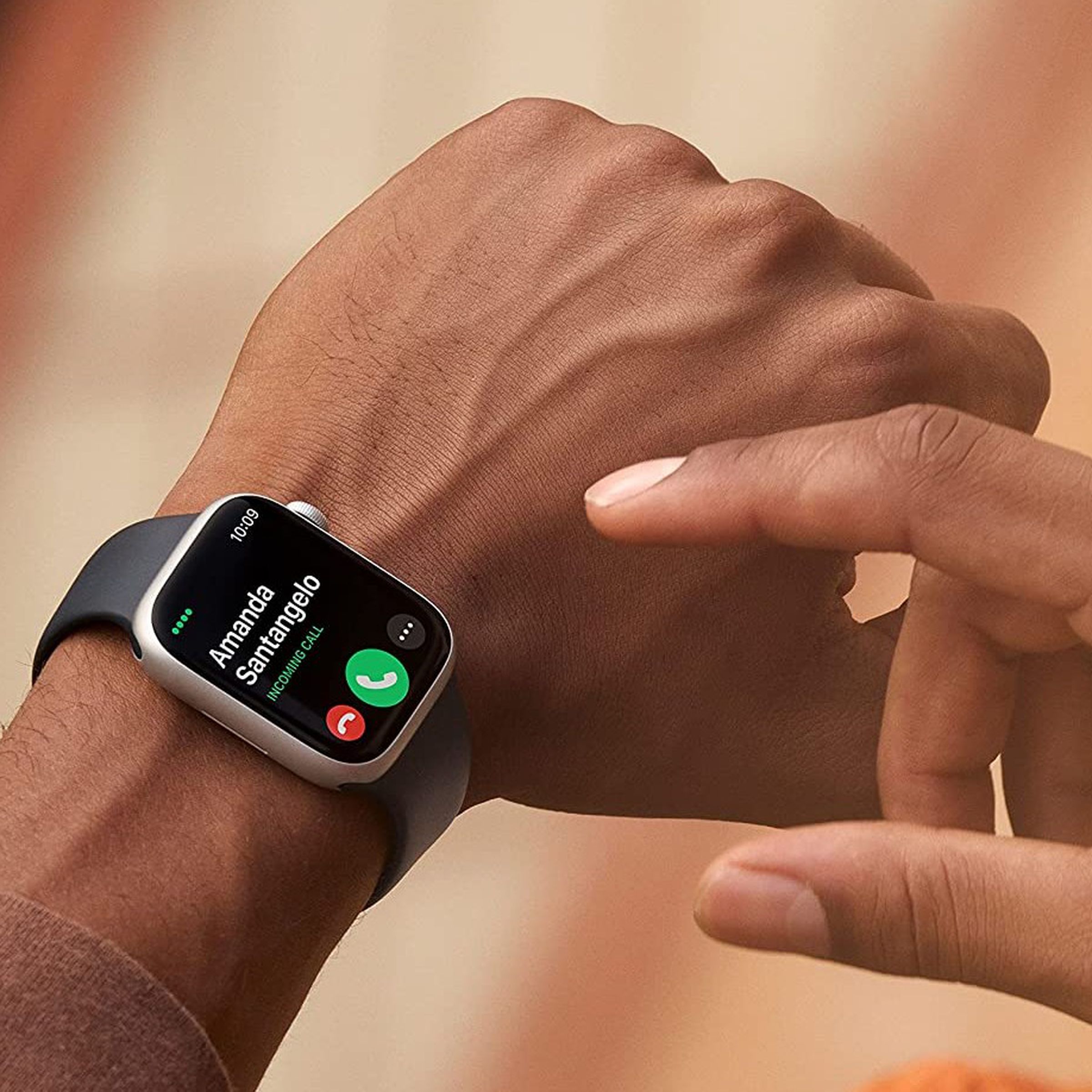 Somebody wearing and about to tap on the Apple Watch Series 8.