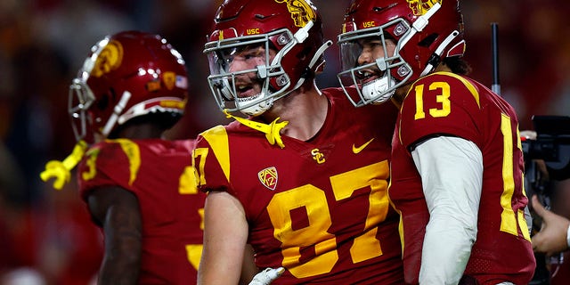 Caleb Williams #13 and Lake McRee #87 of the USC Trojans celebrate a touchdown against the Notre Dame Fighting Irish in the first half at United Airlines Field at the Los Angeles Memorial Coliseum on November 26, 2022 in Los Angeles, California. 