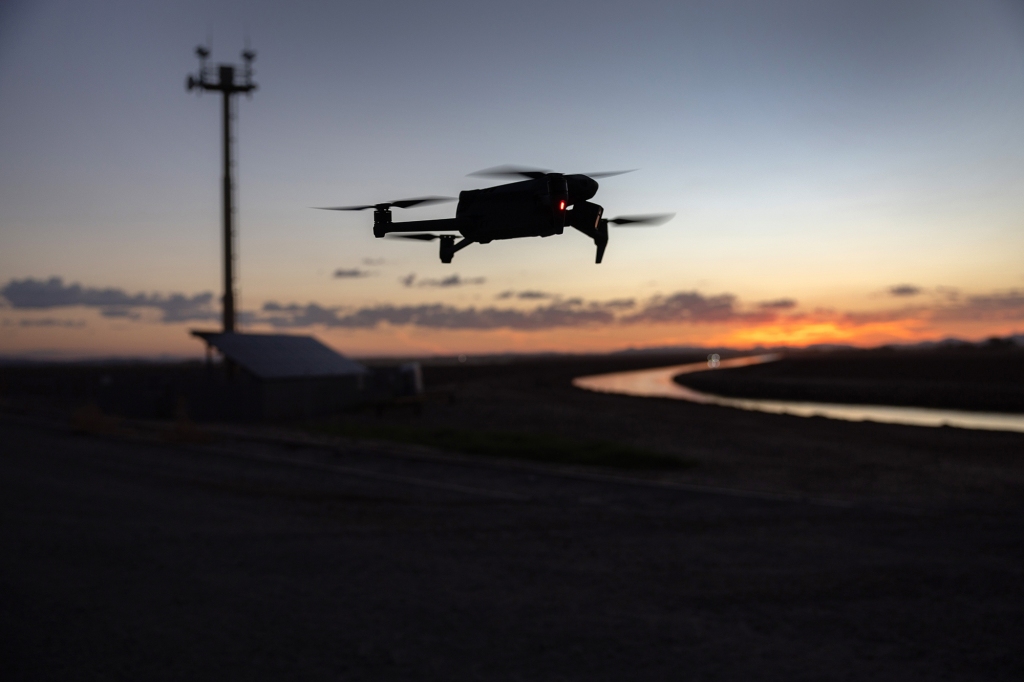 A DJI Mavic 3 drone flies past a surveillance tower in Yuma, Arizona, near the Mexican border on Sept. 27, 2022.