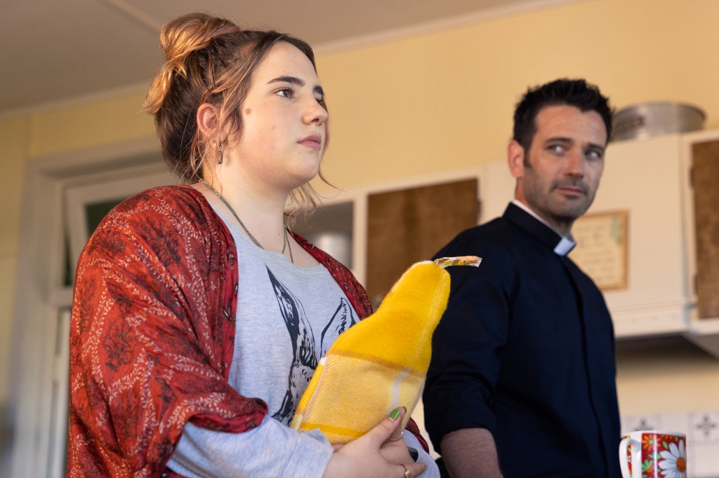 Tegan Stimson as Daisy, Colin Donnell as Mack/Paulo in "Irreverent" standing on a porch. 