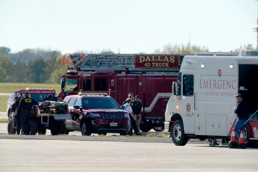 Emergency responders stage on the flightline at the Dallas Executive Airport .