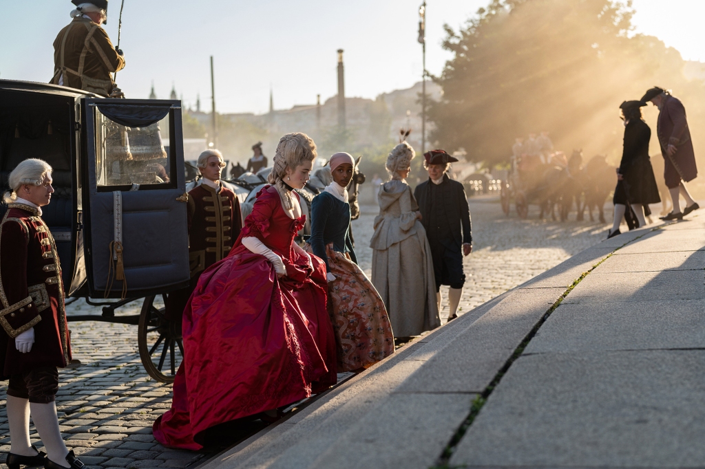 Camille (Alice Englert) in eighteenth century Paris in "Dangerous Liaisons"  walking up steps. 