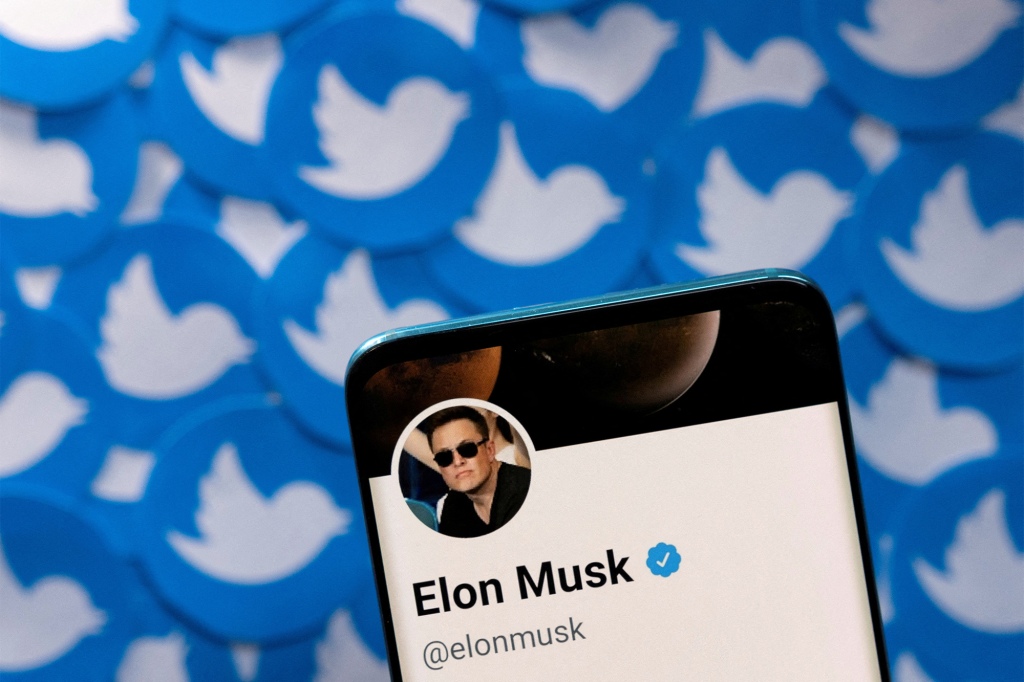 Elon Musk's Twitter profile is seen on a smartphone placed on printed Twitter logos in this picture illustration taken April 28, 2022.