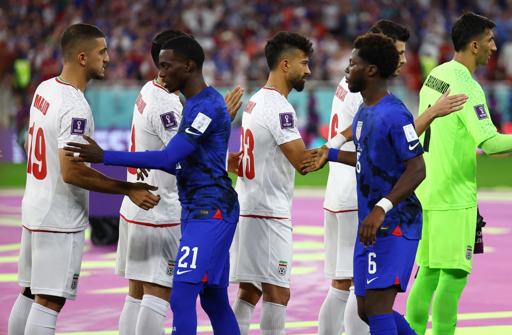 Iran’s match against the US kicked off with sportsmanlike handshakes despite reported threats to the players and unrest roiling their country back home.