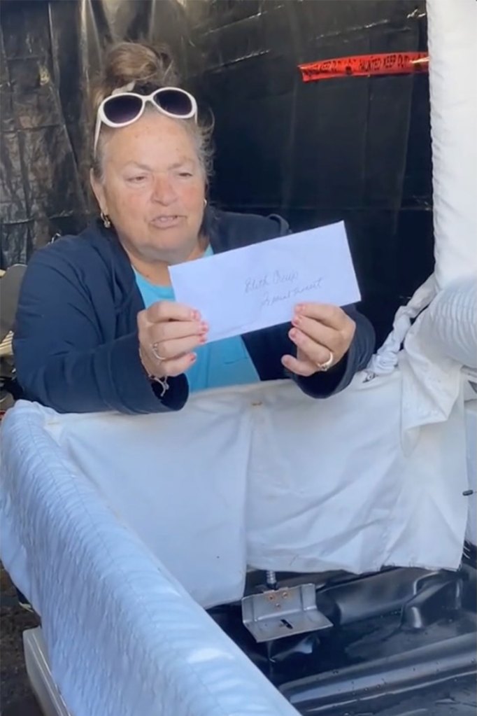 A woman holds an envelope believed to contain Edith Crews' ashes.