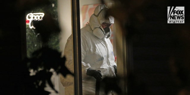 Investigators in hazmat suits examine the scene of a quadruple homicide near the University of Idaho campus.