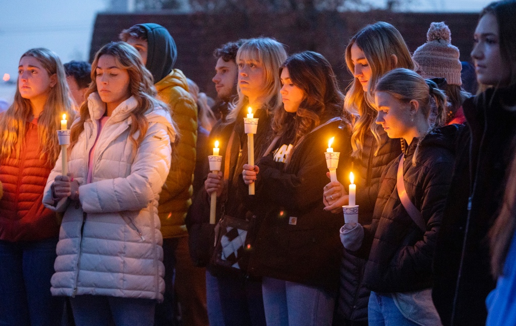 Boise State University students pay their respects to the four at a vigil on Thursday.