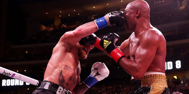 Jake Paul, left, exchanges strikes with Anderson Silva during their cruiserweight bout at Gila River Arena on Oct. 29, 2022 in Glendale, Arizona. 