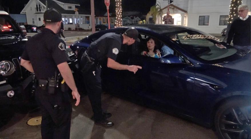 A picture of C.A. police talking with Jay Leno and his wife.