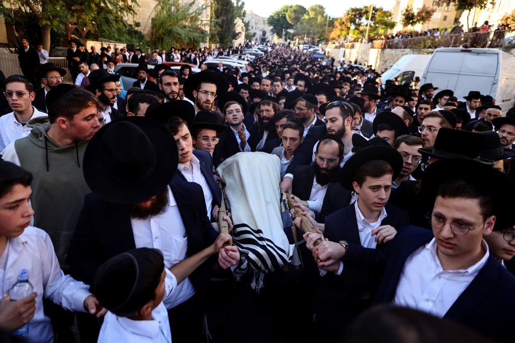 Mourners in Jerusalem carry the body of 16-year-old Aryeh Shechopel at his funeral following a suspected Palestinian bomb attack.