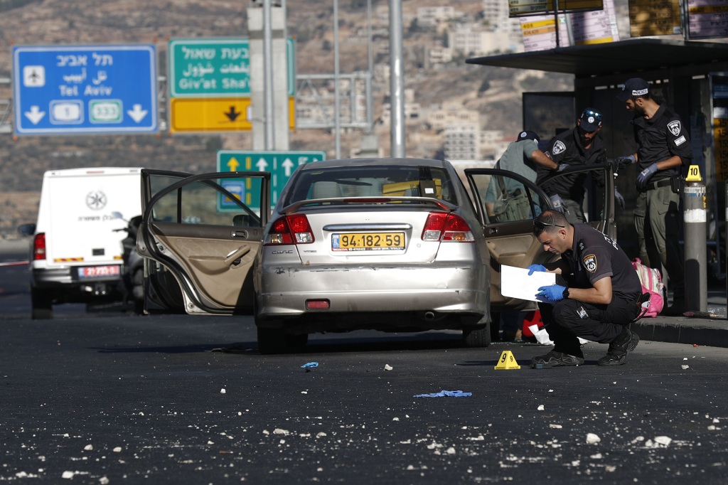 Israeli authorities at the site of the bus-stop bombing near Jerusalem on Nov. 23, 2022. 