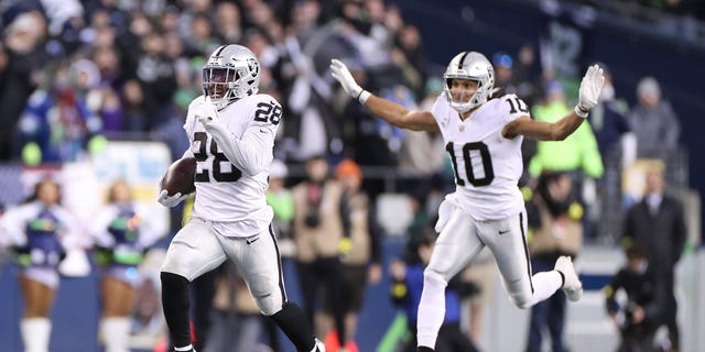 Josh Jacobs (28) of the Las Vegas Raiders runs with the ball in overtime against the Seattle Seahawks at Lumen Field on Nov. 27, 2022, in Seattle, Washington.