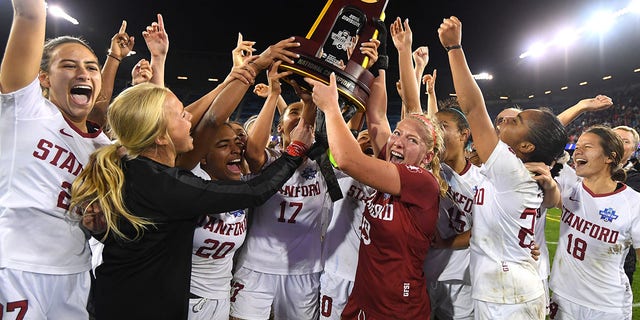 Goalie Katie Meyer (19) of the Stanford Cardinal hoists the trophy after defeating the North Carolina Tar Heels during the Division I women's soccer championship at Avaya Stadium Dec. 8, 2019, in San Jose, Calif.