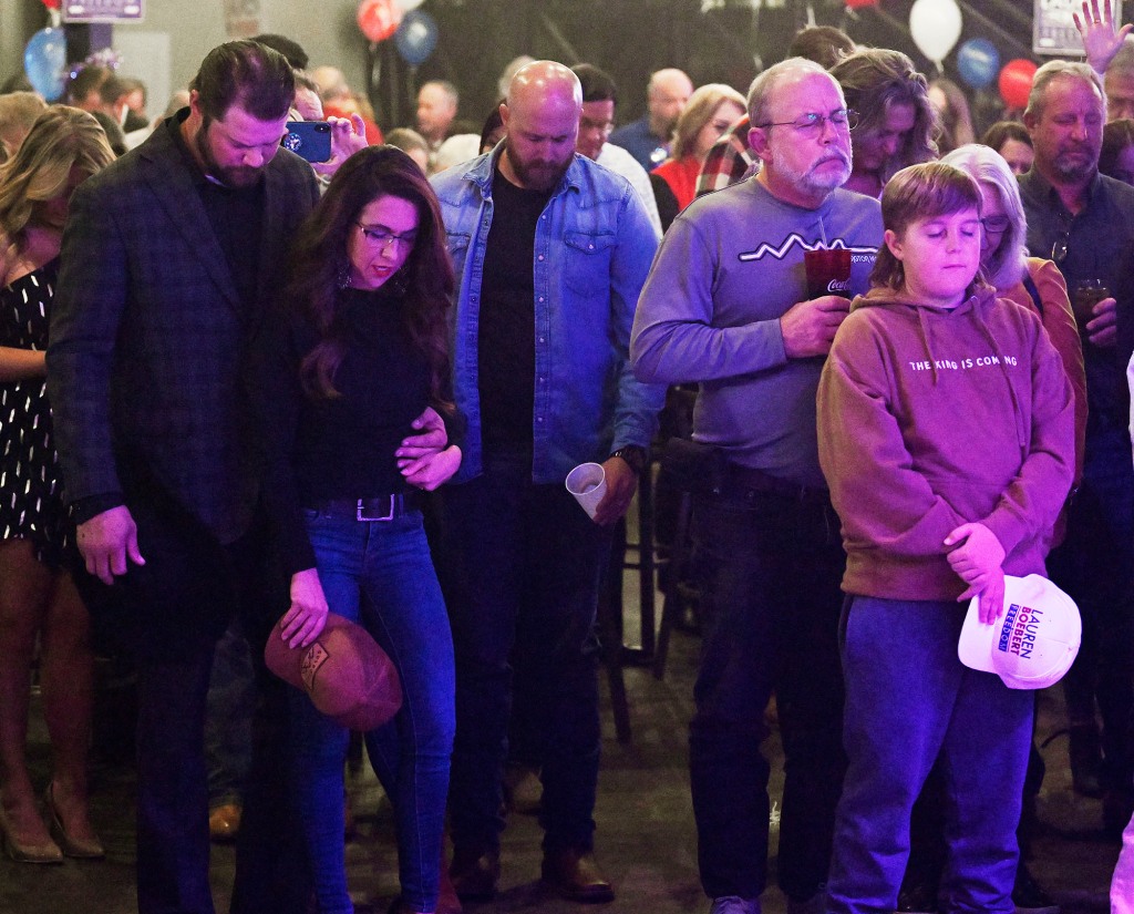 Boebert is seen praying with her husband during an election night party.