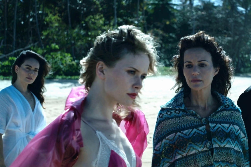 Ana De La Reguera as Inocencia, Amelia Eve as Maru, Carla Gugino as Alba, Gaite Jansen as Batty in "Leopard Skin" all stare off into the distance standing in a yard.  