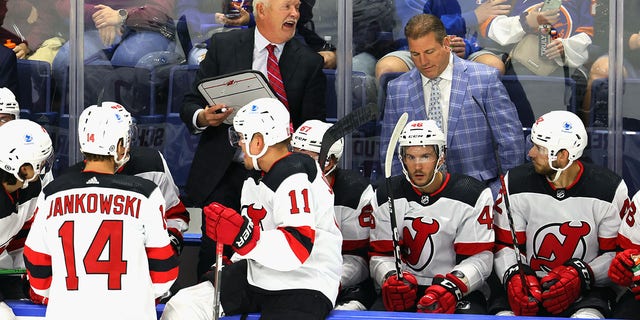 Head coach Lindy Ruff of the New Jersey Devils handles bench duties against the New York Islanders during a preseason game at the Webster Bank Arena at Harbor Yard Oct. 2, 2021, in Bridgeport, Conn.