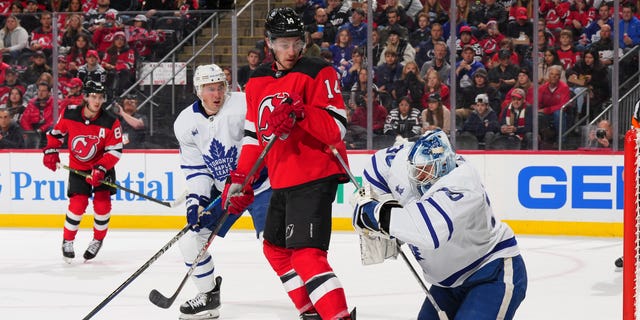 Matt Murray #30 of the Toronto Maple Leafs makes a save in front of Nathan Bastian #14 of the New Jersey Devils in the second period at the Prudential Center on November 23, 2022 in Newark, New Jersey.