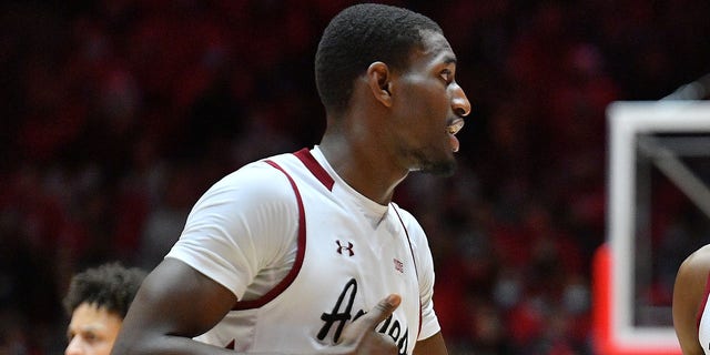 Mike Peake, #15, talks to Sir'Jabari Rice, #10, of the New Mexico State Aggies during their game against the New Mexico Lobos at the Pit on December 6, 2021, in Albuquerque, New Mexico. The Aggies defeated the Lobos 78-76 in overtime.  