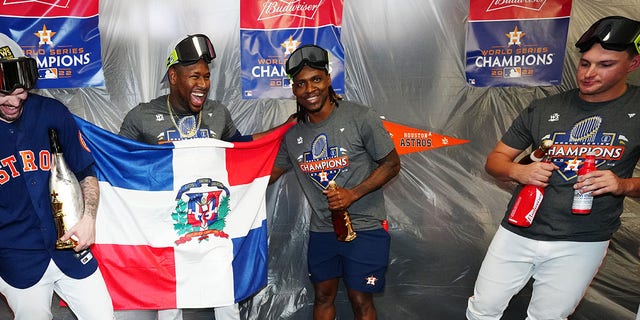 Ryan Pressly, Héctor Neris and Rafael Montero of the Houston Astros celebrate with the World Series trophy in the clubhouse after the Astros defeated the Phillies, 4-1, in Game 6 of the 2022 World Series at Minute Maid Park Nov. 5, 2022, in Houston. 