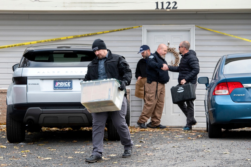 Officers remove evidence from the Moscow home crime scene.