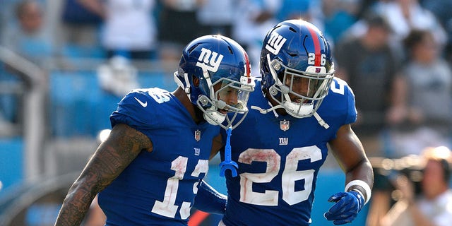 Odell Beckham Jr. #13 and Saquon Barkley #26 of the New York Giants during their game against the Carolina Panthers at Bank of America Stadium on October 7, 2018, in Charlotte, North Carolina. The Panthers won 33-31. 