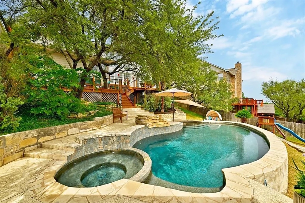 The abode in Austin has both a pool and a hot tub.