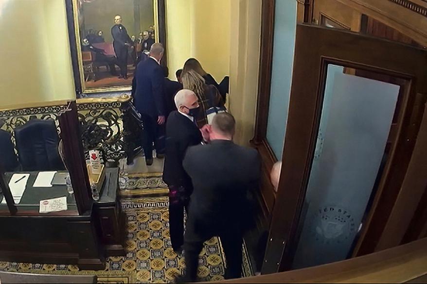 Pence being evacuated from the Senate chamber of the Capitol building on January 6, 2021.