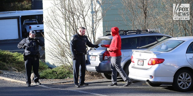 Police in Idaho talk to a man.