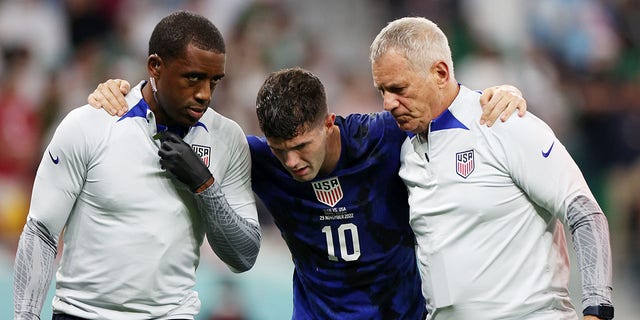 Christian Pulisic of the United States receives medical treatment after scoring a goal during a FIFA World Cup Qatar 2022 Group B match against Iran at Al Thumama Stadium Nov. 29, 2022, in Doha, Qatar.