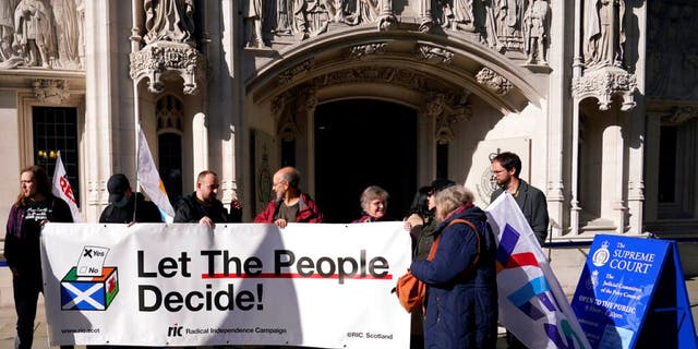 Supporters of Scottish Independence hold a banner outside the Supreme Court in London, Tuesday, Oct. 11, 2022. Britain’s Supreme Court is due to rule Wednesday, Nov. 23, 2022, on whether Scotland can hold a vote on independence without the consent of the U.K. government, a case with huge implications for the future of the United Kingdom.