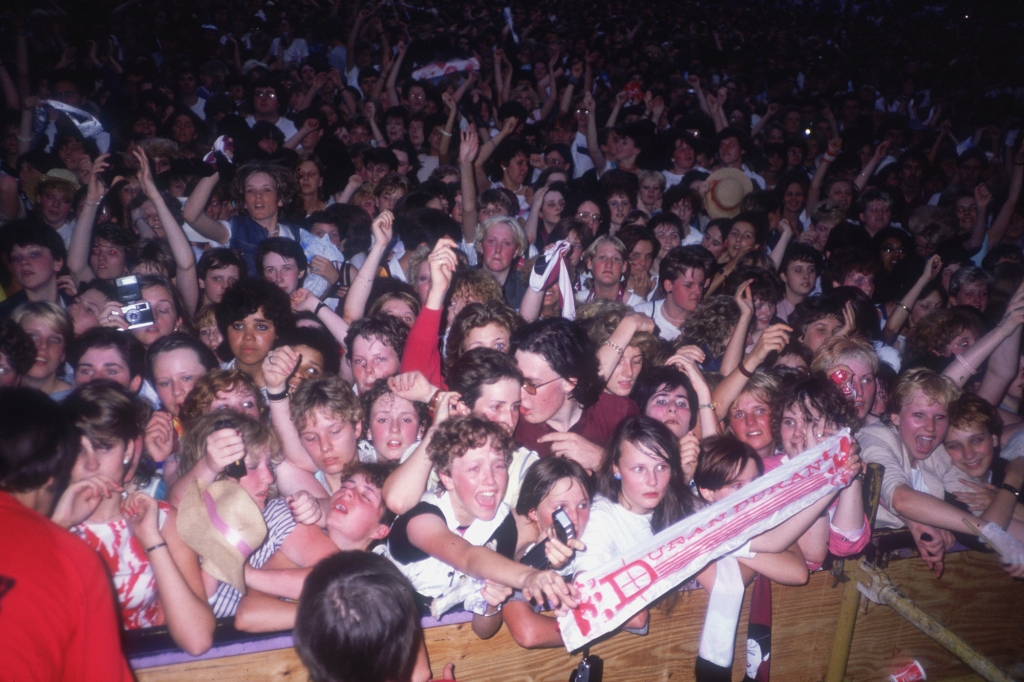 At concert like this one in 1983, female fans would literally throw themselves at the band members. 