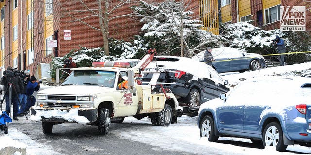 A Ford Explorer relevant to the investigation of four murdered college students in Moscow, Idaho is towed by police investigators