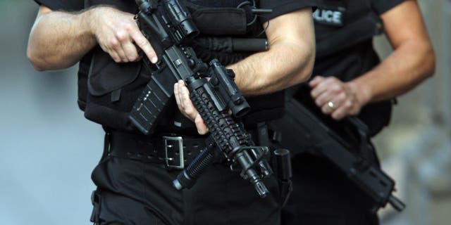 Armed police patrol outside the Royal Court Building in St Hellier Jersey before the arrival of Curtis Warren, who is accused alongside six other men over an alleged drug smuggling plot.