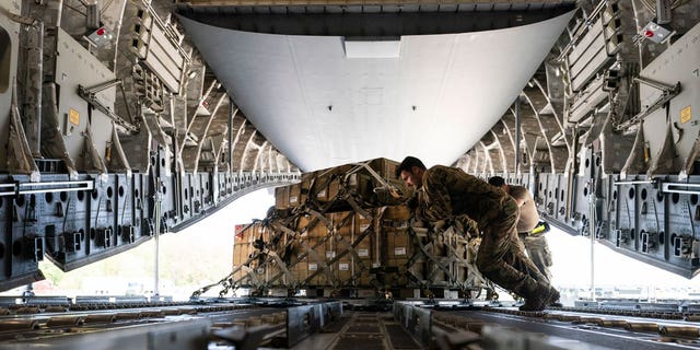 A pallet of fuses for 155 mm shells, ultimately bound for Ukraine, is spun as it's loaded on to a C-17 cargo aircraft, April 29, 2022, at Dover Air Force Base, Del. 