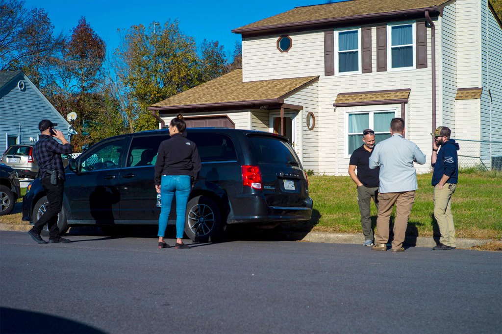 Police are spotted outside of night manager Andre Bing's home following the shooting.
