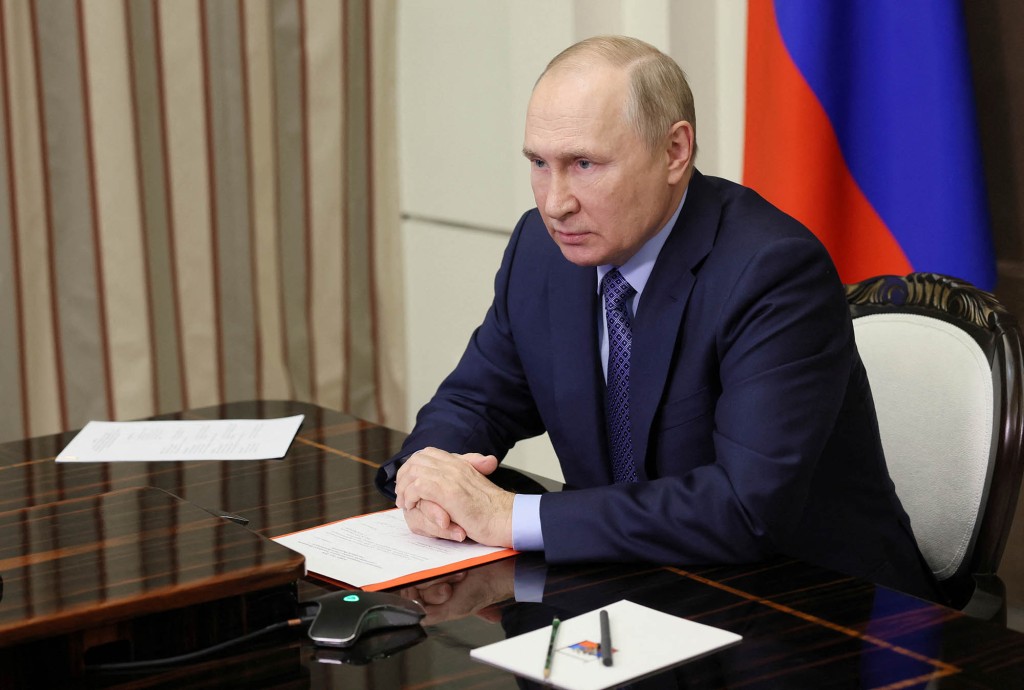 Putin holding his hands during a meeting Wednesday.