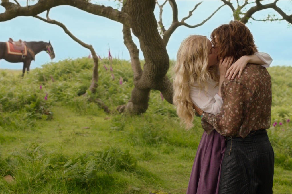 Dove (Ellie Bamber) and Airk (Dempsey Bryk) in "Willow" kissing by a tree. 