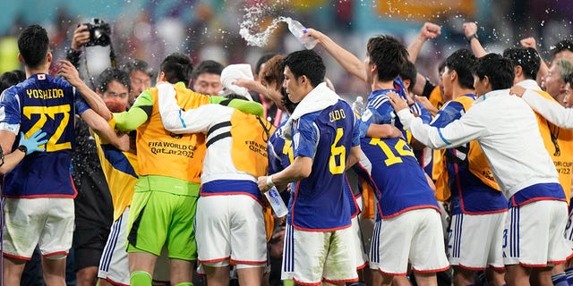 Japan players celebrate after the World Cup Group E soccer match between Germany and Japan at Khalifa International Stadium in Doha, Qatar, Wednesday, Nov. 23, 2022.