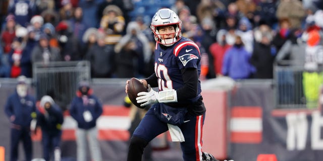 Mac Jones of the New England Patriots attempts a pass against the Cincinnati Bengals at Gillette Stadium on Dec. 24, 2022, in Foxborough, Massachusetts.