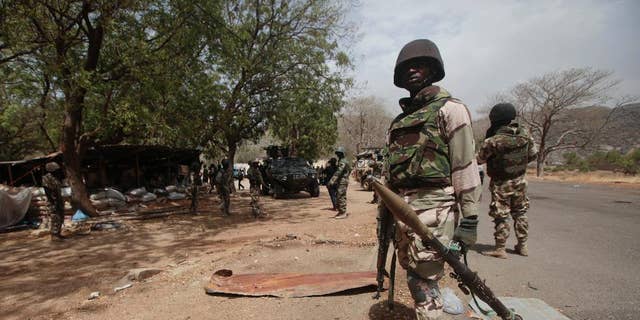 FILE - Nigerian soldiers man a checkpoint in Gwoza, Nigeria, a town liberated from Boko Haram, April 8, 2015.