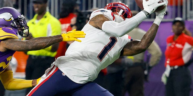 DeVante Parker (1) of the New England Patriots catches a pass over Duke Shelley of the Minnesota Vikings during the third quarter at U.S. Bank Stadium Nov. 24, 2022, in Minneapolis.