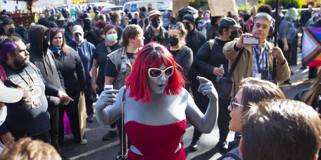 Drag performer arguing with protesters at drag queen story time event, outside Old Nick's Pub in Eugene, Oregon, October 23, 2022. 