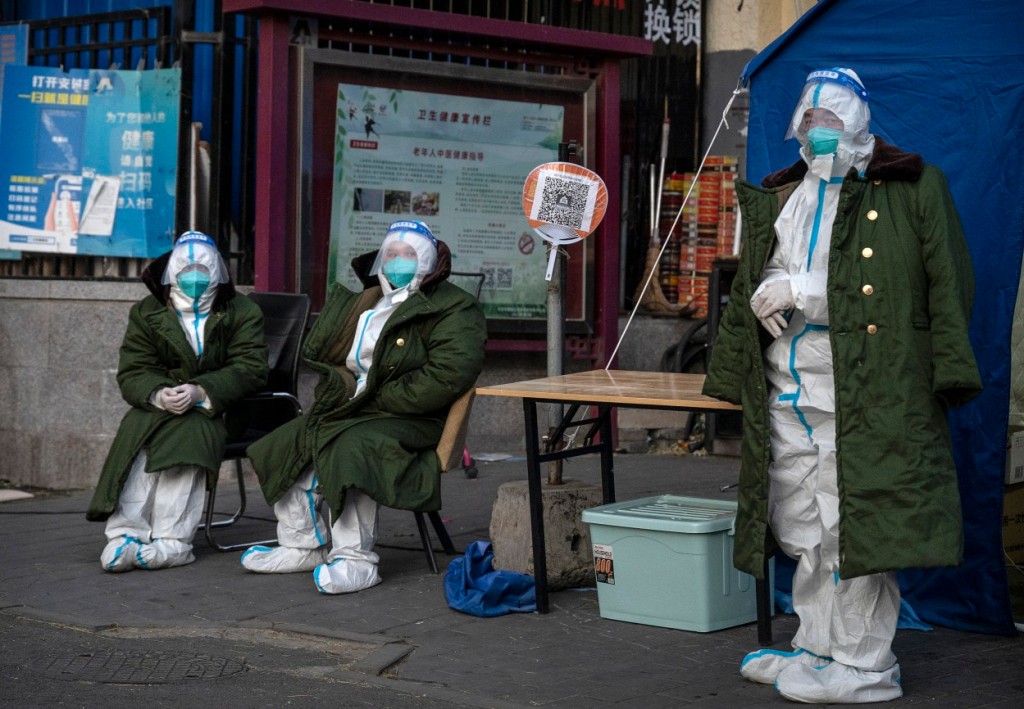 Epidemic control workers wear PPE to prevent the spread of COVID-19 as they guard in an area with communities in lockdown on Dec. 1, 2022 in Beijing, China.