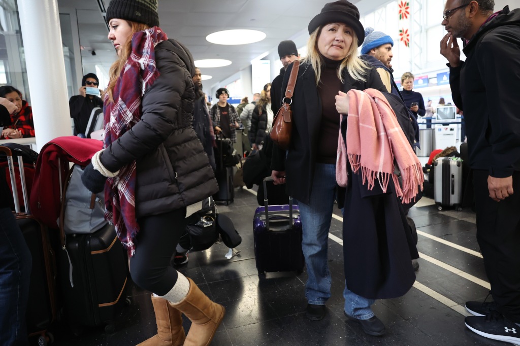 Travelers arrive for flights at O'Hare International Airport on Dec. 22, 2022 in Chicago, Illinois.