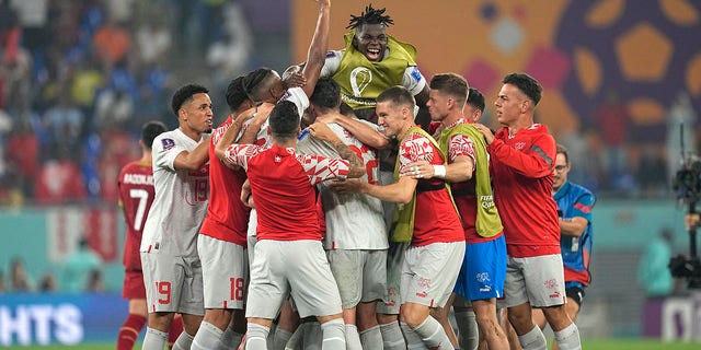 Switzerland's players celebrate their 3-2 win at the end of a World Cup Group G soccer match against Serbia at Stadium 974 in Doha, Qatar, Saturday, Dec. 3, 2022. 