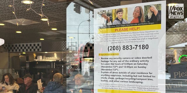 A sign posted in a local diner in Moscow, Idaho, on Monday asks the public to look for clues in the quadruple homicide of four students from the University of Idaho.