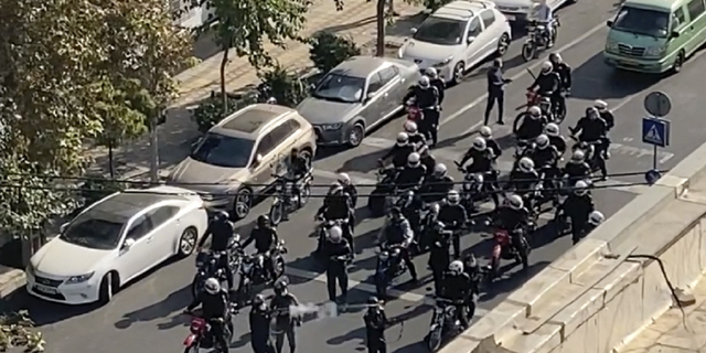 Iranian police arrive to disperse a protest to mark 40 days since the death in custody of 22-year-old Mahsa Amini, whose tragedy sparked Iran's biggest antigovernment movement in over a decade, in Tehran, Iran, Oct. 26, 2022.